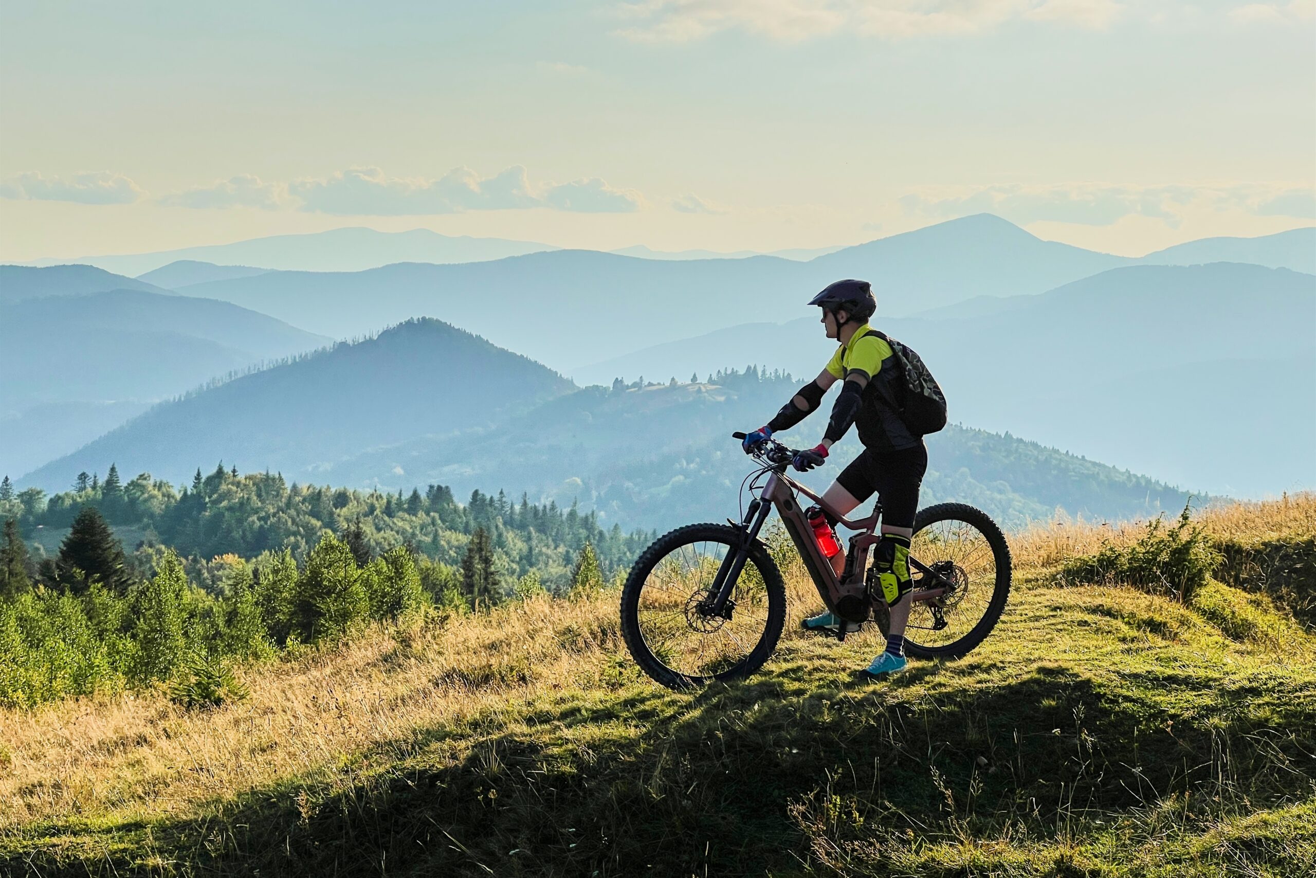 Cyclist,Man,Riding,Electric,Bike,Outdoors,On,Sunny,Day.,Male